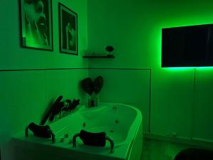 a green bathroom with a tub and a tv at Orléans Centre - LOVE ROOM - Good Vibes Only in Orléans +23 photos
