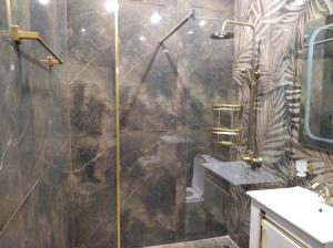 a bathroom with a glass shower with a sink at Very beautiful new apartment in Yerevan +10 photos