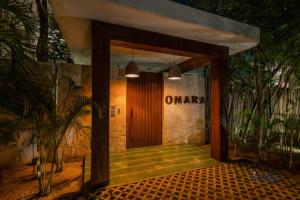 an entrance to a building with a wooden door at Private Rooftop 1BR Condo with Stunning Common Areas in Tulum