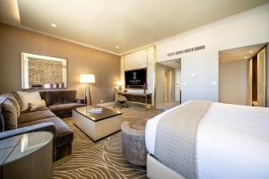 a hotel room with a bed and a living room at SAHARA Las Vegas in Las Vegas