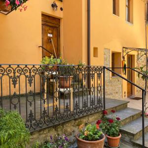 a balcony with potted plants on a house at La Corte in Arezzo