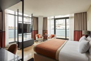 a hotel room with a bed and a large window at Hotel Indigo Newcastle by IHG in Newcastle upon Tyne