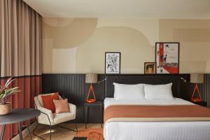 a hotel room with a bed and a chair at Hotel Indigo Newcastle by IHG in Newcastle upon Tyne