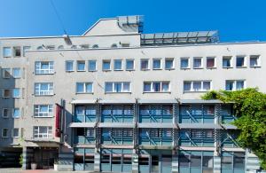 an apartment building with balconies on the side of it at Leonardo Hotel Nürnberg in Nuremberg