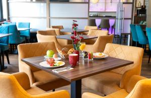 a table with food on it in a restaurant at Leonardo Hotel Nürnberg in Nuremberg