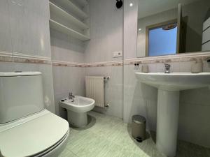 a bathroom with a toilet and a sink at O Faiado Da Ria By Oktheway in Culleredo +28 photos