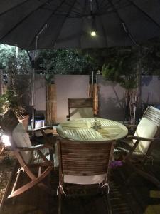 a table with two chairs and an umbrella at Studio47 in Athens