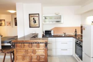 a kitchen with white cabinets and a counter top at Apartment Istra in Poreč