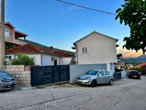 a car parked in front of a house at Apartmani Andrić - Stylish & Peaceful Apartment with Free Parking - 10 min Walk to Old Town in Trebinje