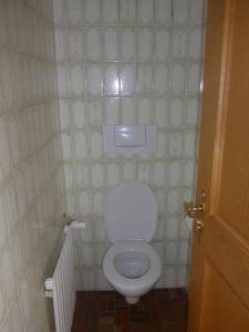 a bathroom with a white toilet in a tiled room at Haus Mayer in Weilheim in Oberbayern