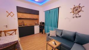 a living room with a blue couch and a kitchen at STELIA view apartment in Panagia