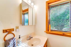a bathroom with a sink and a mirror and a window at Tallassee Family Home with Stunning Smoky Mtn Views in Tallassee +32 photos