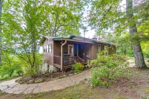 a small house with a porch in the woods at Tallassee Family Home with Stunning Smoky Mtn Views in Tallassee