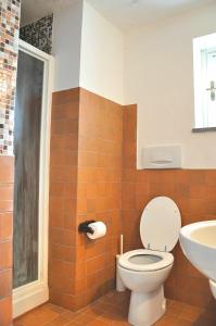 a bathroom with a toilet and a sink at Montecasciano - Papavero in Capranica +38 photos