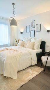 a bedroom with a large bed with white sheets and pillows at Hotel Fewotal & Luxury 5 - nähe Messe Düsseldorf & Köln in Wuppertal