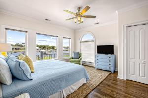 a bedroom with a bed and a ceiling fan at Sunset Villa in Holden Beach