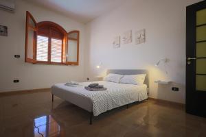 a bedroom with a bed in a room with a window at Casa di Sara&Anna in Avola