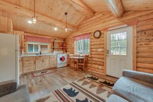 a log cabin kitchen with a table and a door at Charming Soldotna Cabin Near Kenai River Fishing! in Soldotna +18 photos