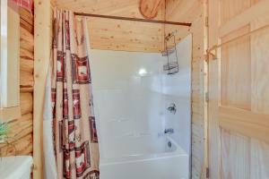 a bathroom with a shower and a white tub at Charming Soldotna Cabin Near Kenai River Fishing! in Soldotna
