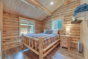 a bedroom with a bed in a log cabin at Soldotna Fishermans Cabin about 6 Mi to Kenai River in Soldotna