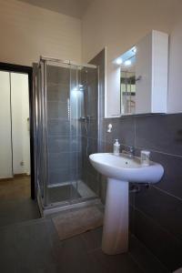 a bathroom with a sink and a shower at Casa di Sara&Anna in Avola