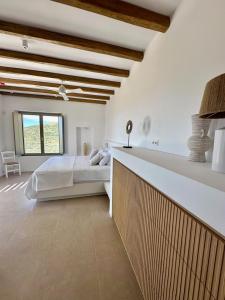 a white bedroom with a bed and a large window at Olive Breeze Villa , Naousa in Kampos Paros +43 photos