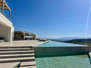 a house with a swimming pool with a view at Olive Breeze Villa , Naousa in Kampos Paros