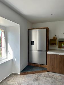 a kitchen with a stainless steel refrigerator in a room at Mas Chantequinson in Les Assions +35 photos