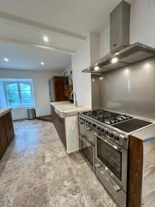 a kitchen with a stove and a sink at Mas Chantequinson in Les Assions