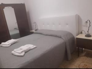 a bedroom with a bed with two towels on it at Villa Salvina Beach in Fontane Bianche