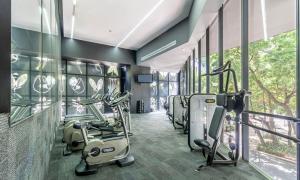 a fitness room with treadmills and elliptical machines at Casa Magenta by Kukun in Mexico City