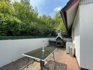 a patio with a table and a grill at BärenNest Haus in Kirchheim
