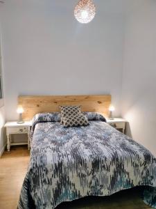een slaapkamer met een bed en twee nachtkastjes bij Apartamento en el barrio marítimo del Serrallo in Tarragona