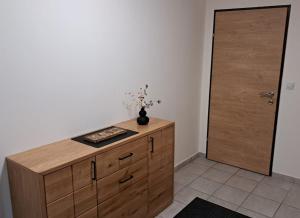 a wooden cabinet in a room with a door at In der Wachau in Weissenkirchen in der Wachau