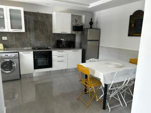 a kitchen with a table and a table and chairs at Darna in Bizerte