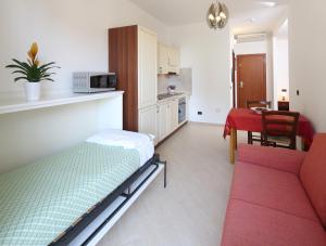 ein Wohnzimmer mit einem Bett und eine Küche in der Unterkunft Residence Hotel Kriss in Deiva Marina