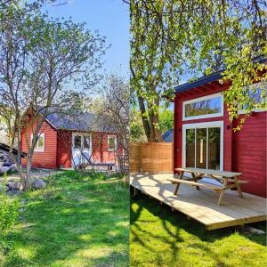 a red tiny house with a picnic table on a deck at Tiny houses Liv & Lea in Listerby