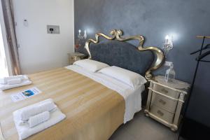 a bedroom with a large bed with a gold frame at Residenza Luce Sul Mare in Tropea