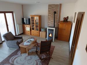 a living room with a table and a chair at Apartman Vukan in Bajina Bašta