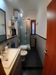a bathroom with a shower and a toilet and a sink at La Casa di Emilio in Piombino
