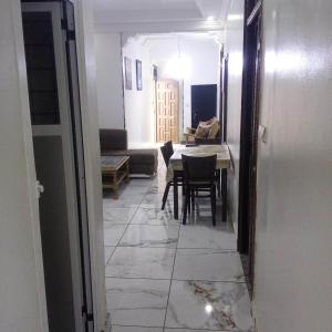 a hallway with a table and chairs in a room at casa omar in Chefchaouene