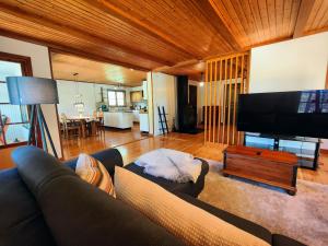 a living room with a couch and a flat screen tv at Haus Lagom in Johannishus