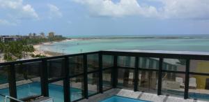 a view of the beach from the balcony of a building at Neo Maceió - Aparts à Beira-Mar em Pajuçara in Maceió