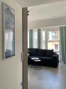 a mirror in a living room with a black couch at Sea Side apartments in Santa Pola +45 photos