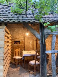 a table and chairs sitting inside of a cabin at House by the Church - entire house in Criţ
