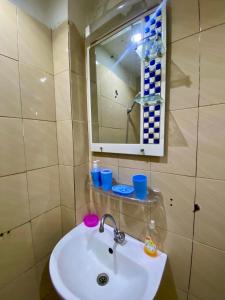 uma casa de banho com um lavatório e um espelho em Chez Danie em Dakar