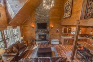 a living room with a fireplace in a cabin at Black Bear Cabin by Stony Brook Cabins in Gatlinburg