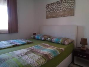 two beds sitting next to each other in a room at Apartments Lili in Zadar