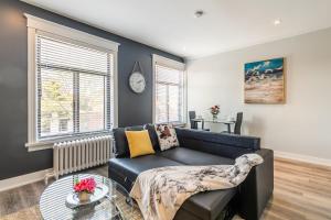a living room with a couch and a table at Cozy Condo on James Street North in Hamilton +11 photos