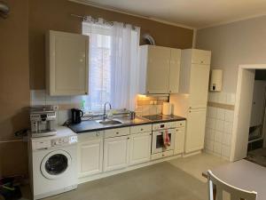 a kitchen with a sink and a washing machine at Apartment in Herne 4 in Herne